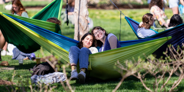 Students of Washington University hang out in hammocks.