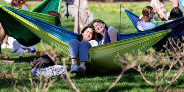 Washington University Students relaxing in hammocks on campus.
